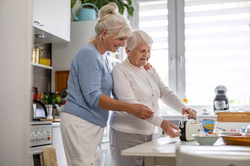 Elderly woman with her caregiver at nursing home